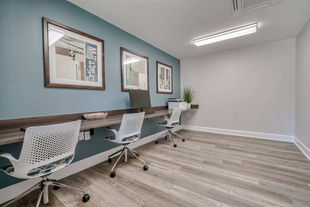 a conference room with a long desk and three chairs