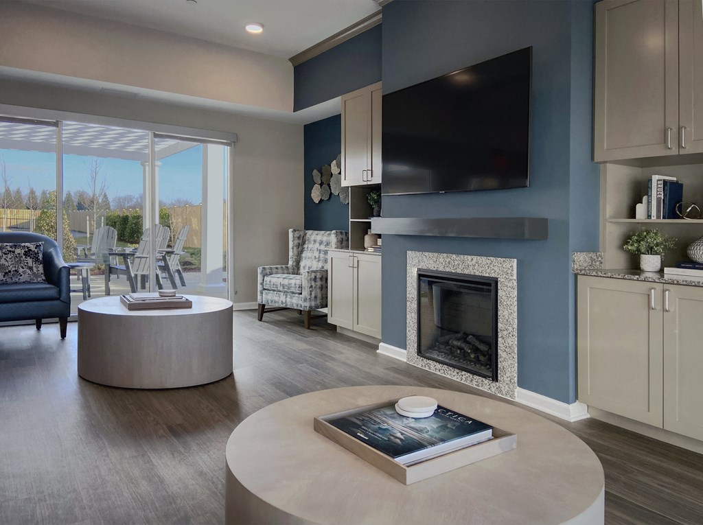 a living room with a fireplace and a table with a book