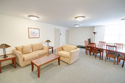 Living room with a couch, chairs, and a coffee table.
