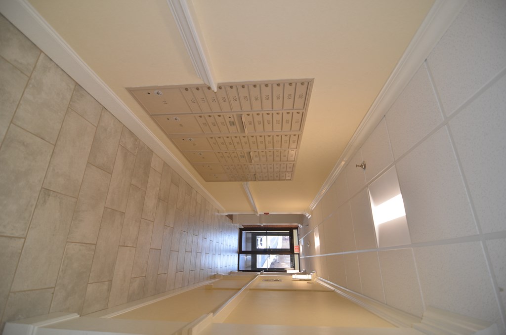 a view down a long corridor with a window at the end