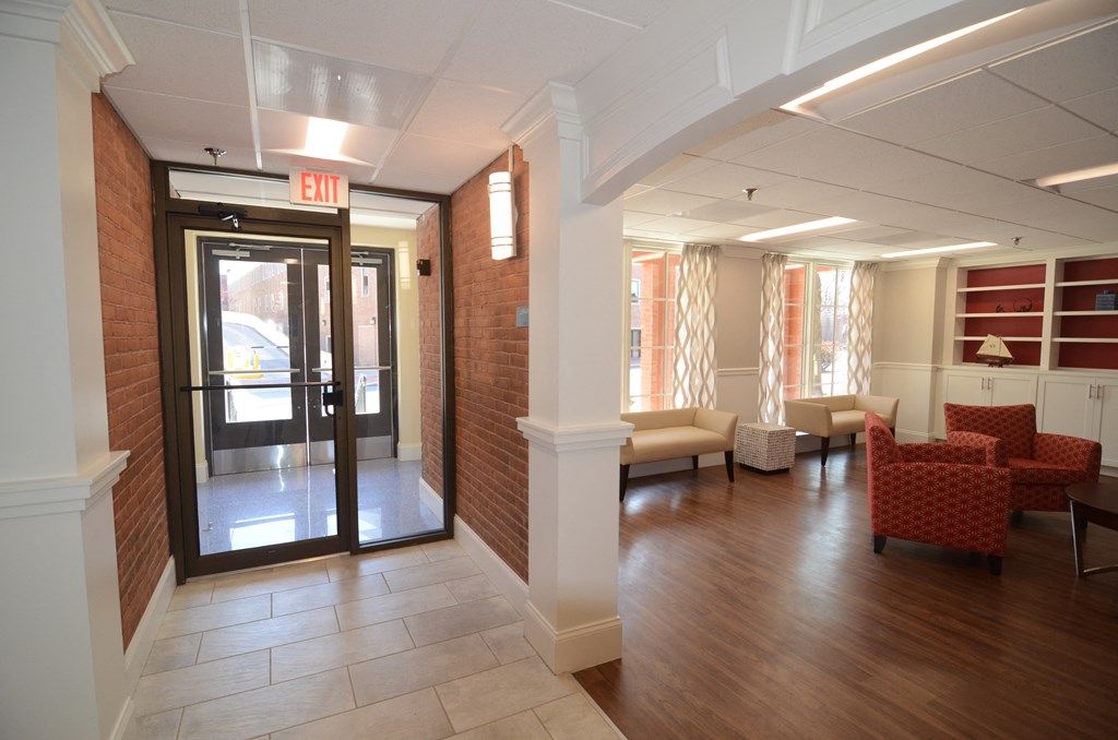 a view of the entrance to the leasing office with couches and chairs