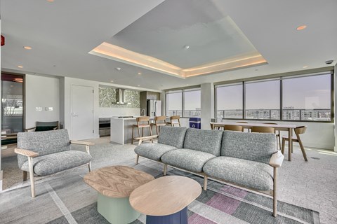 A living room with grey sofas and a wooden coffee table.