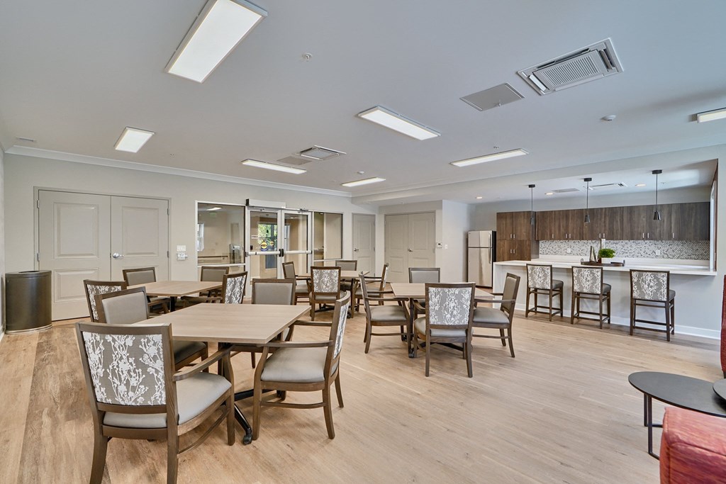 A large room with a dining table and chairs.