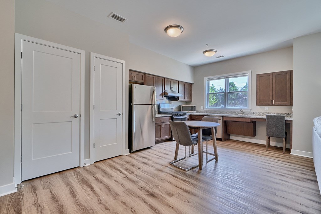 A kitchen with a table and chairs in the middle of the room.