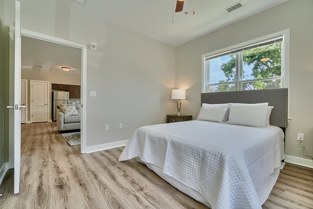A bedroom with a large bed and a window.