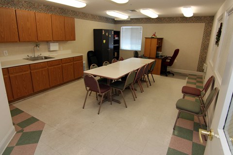 a dining room with a table and chairs and a kitchen