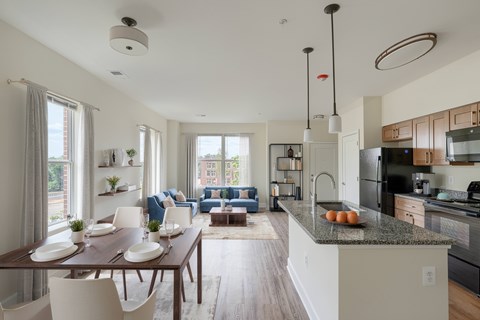 A modern kitchen with a dining table and chairs.