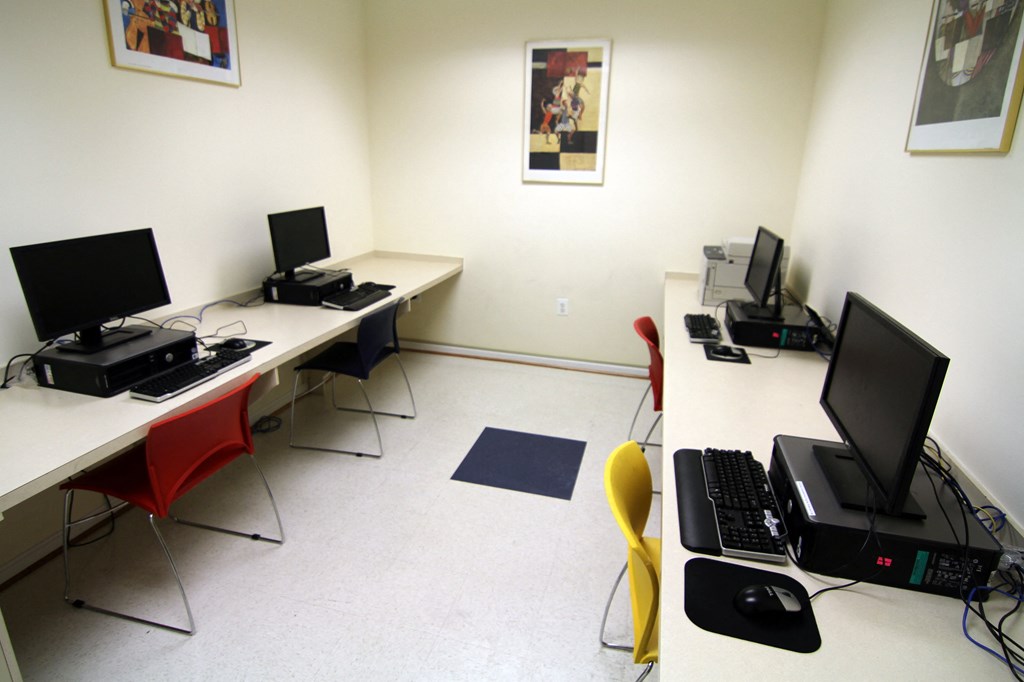 a computer room with desks and computers