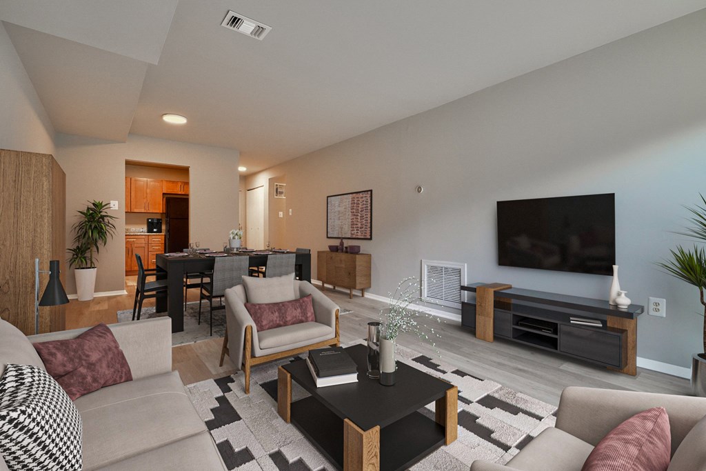 a living room and dining room with a couch and a tv