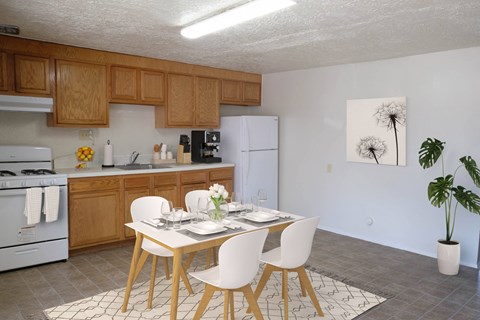an open kitchen and dining room with a table and chairs