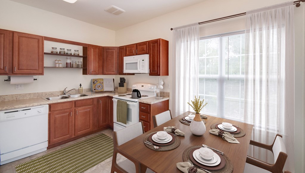 a kitchen and dining room with wooden cabinets and a table