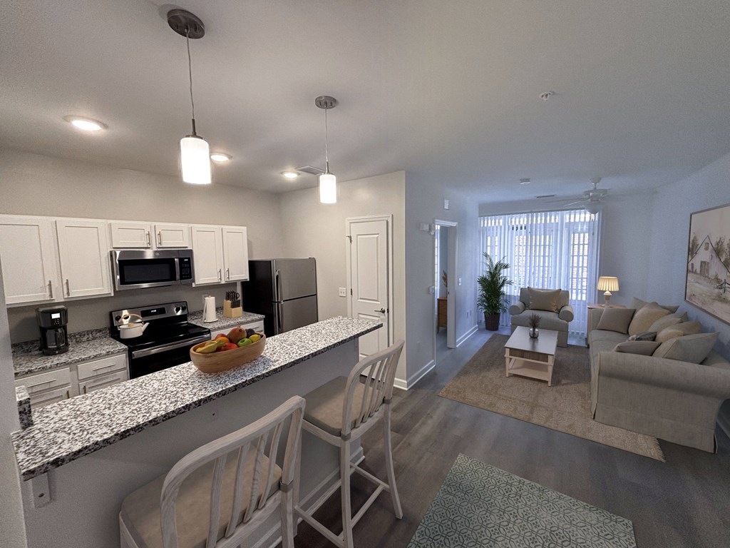 an open living room and kitchen with a granite counter top