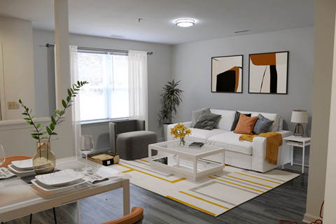 a living room with a white couch and yellow and gray accents