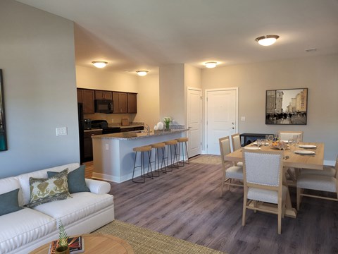 an open living room and kitchen with a dining room table and chairs