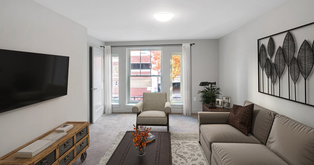 a living room with a couch and a chair and a television