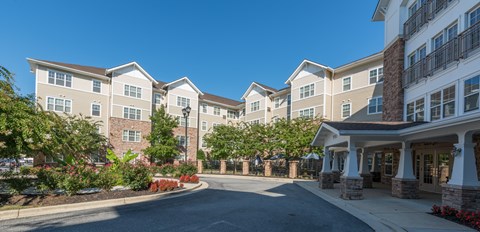A large building with a driveway in front of it.