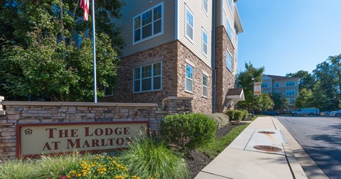The Lodge at Marlton sign in front of a building.