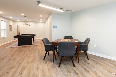a dining room with a table and chairs and a pool table