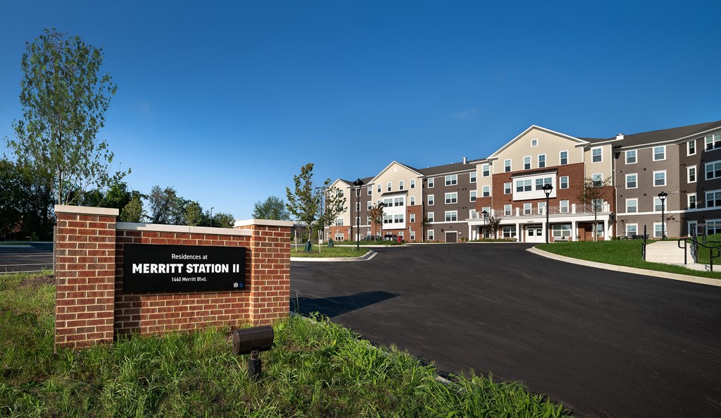 an empty parking lot in front of an apartment building