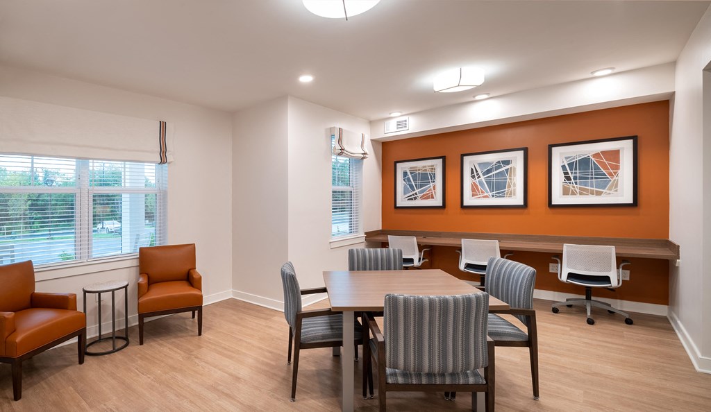 a conference room with a table and chairs and a window