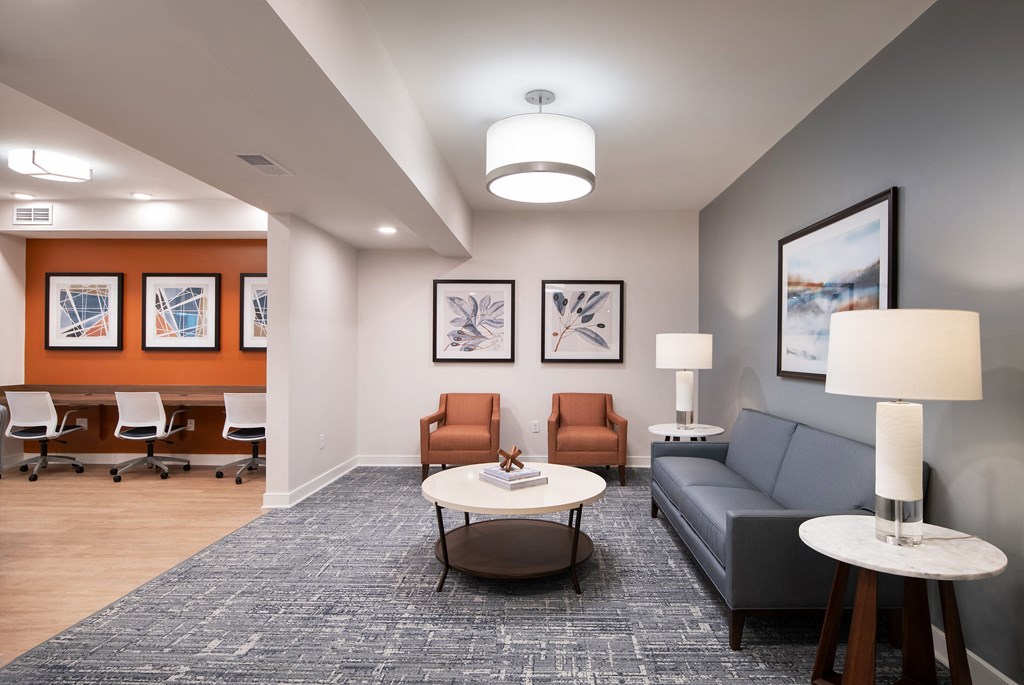 a living room with couches and chairs and a table