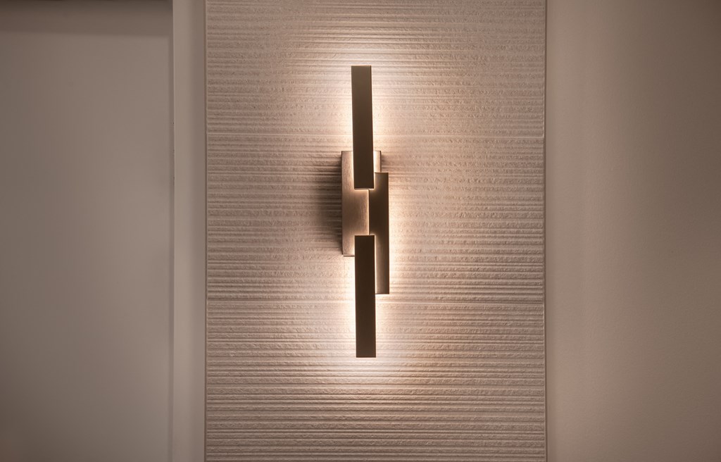 a wall light with a shadow on a wall