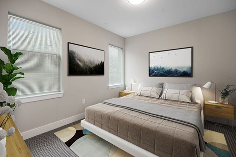 A bedroom with a large bed and two pictures on the wall.