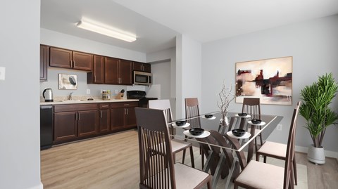 A modern kitchen with a dining table set for four.