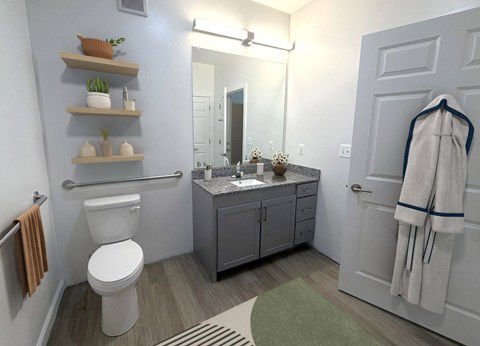 A bathroom with a toilet, sink, mirror, and towel rack.