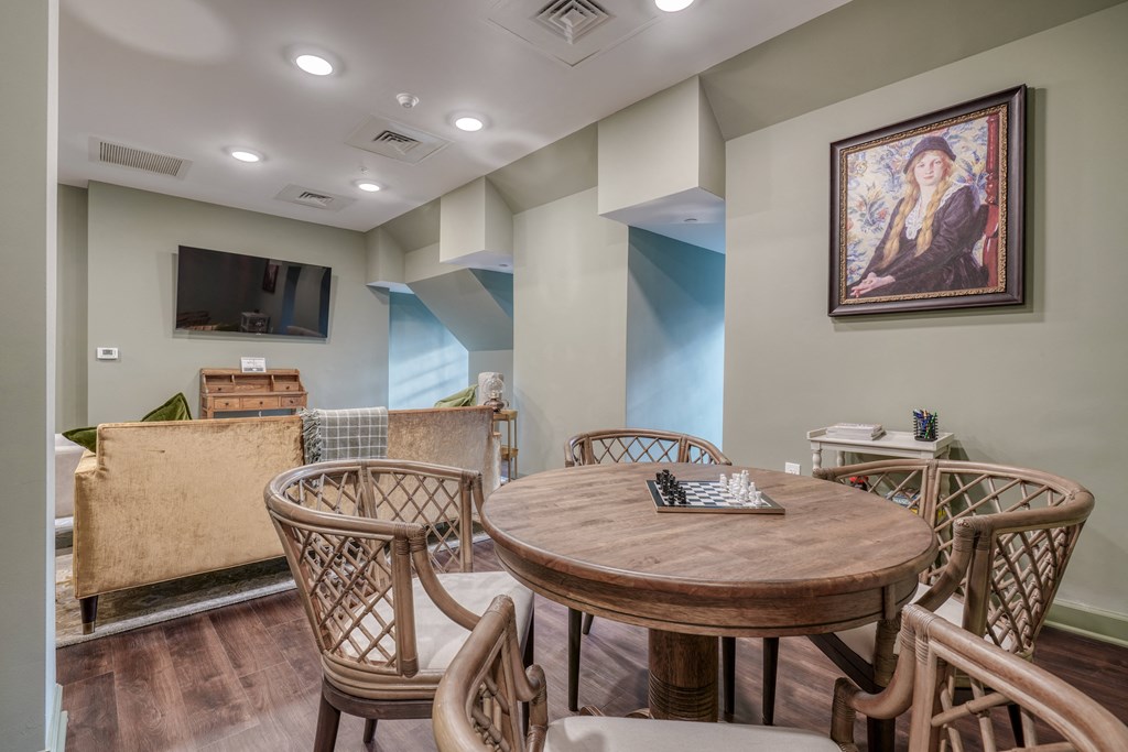 a dining area with a table and chairs and a living room with a television