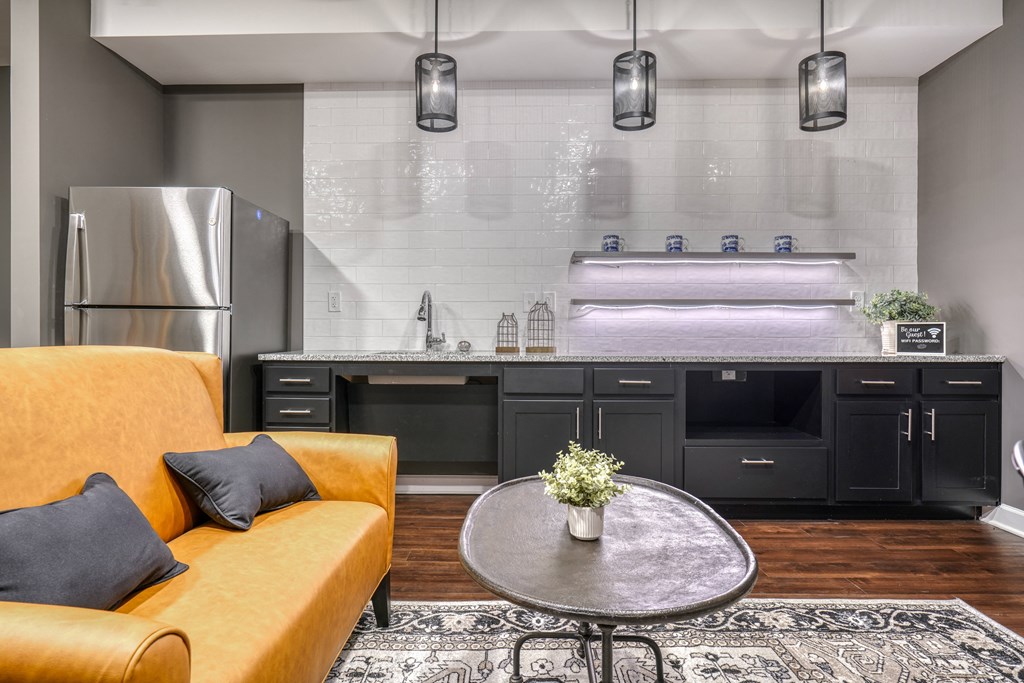 a kitchen and living room with yellow couches and a table