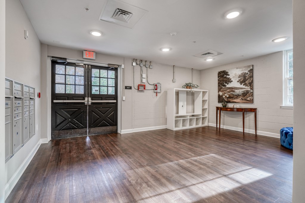 the living room has a large room with wood floors and white walls and black doors