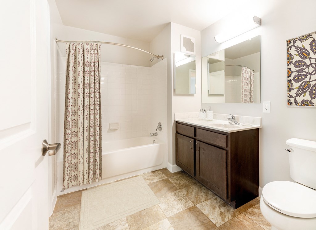 a bathroom with a shower and a sink and a toilet