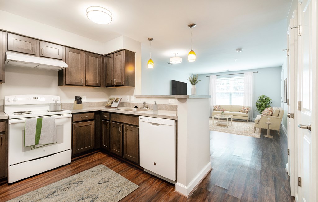 a kitchen with white appliances and dark wood cabinets