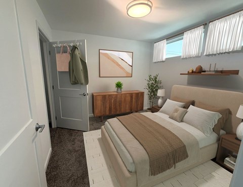 A bedroom with a bed, nightstand, and a small plant on the nightstand.