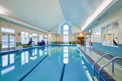 a swimming pool in a building with a large window