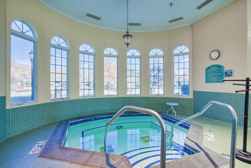 a spa with a pool and a row of windows