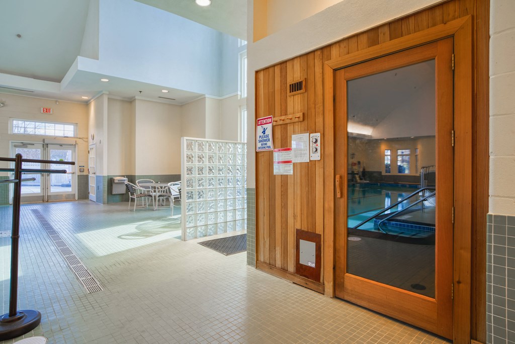 a wooden door in a lobby of a building with a pool