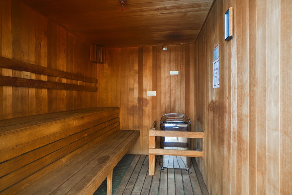 a wooden sauna with a bench and a table