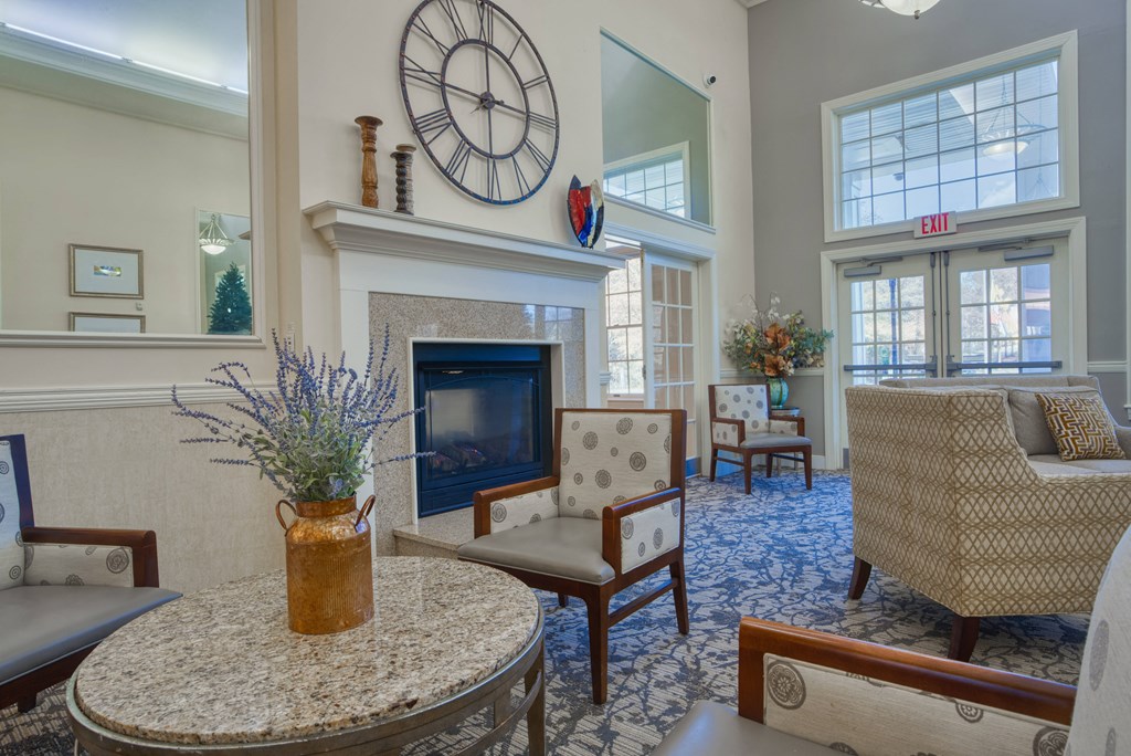 a living room with a fireplace and a clock on the wall