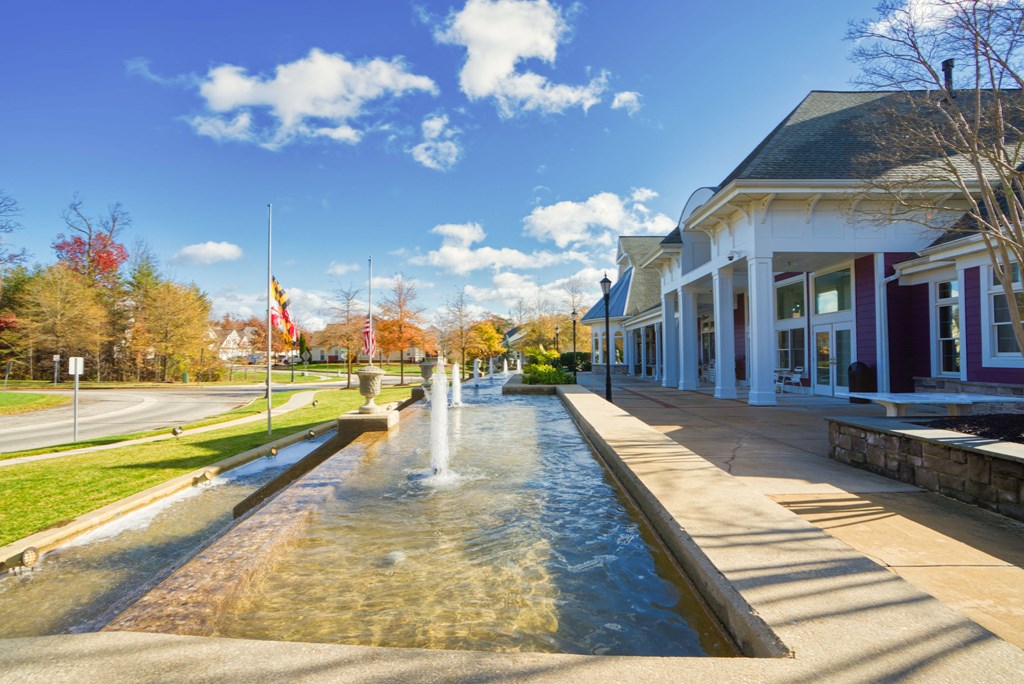 a fountain in front of a building on a sunny day