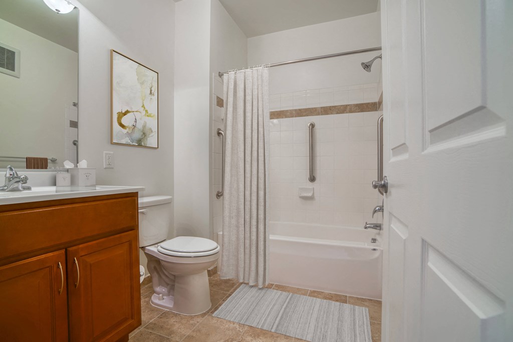 a bathroom with a shower and a toilet and a sink