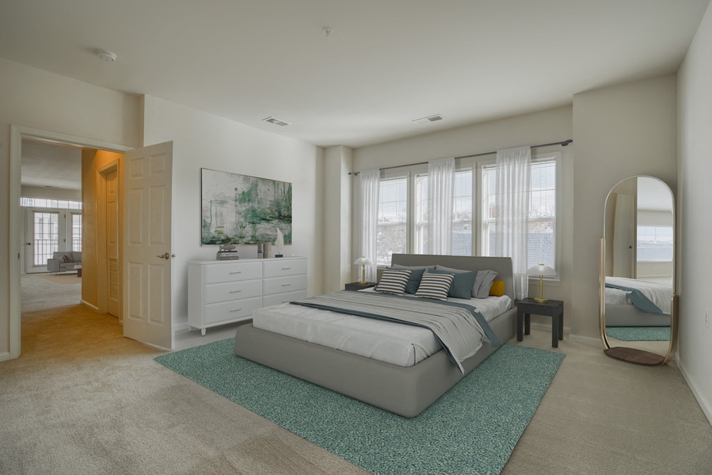 a bedroom with a bed and a dresser and a mirror