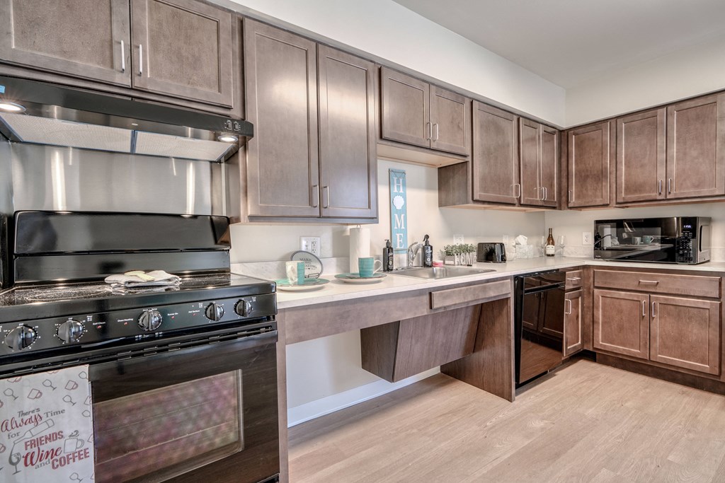 a kitchen with stainless steel appliances and wooden cabinets