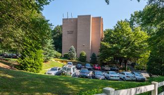 a parking lot with cars in front of a tall building
