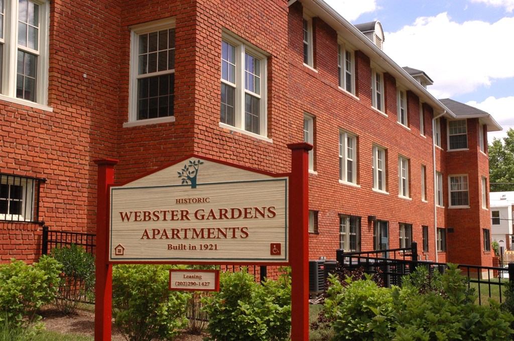 Exterior of building with sign that says Webster Garden Apartments