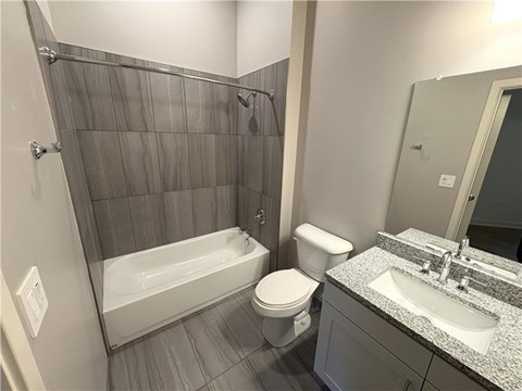 A bathroom with a white toilet, a white sink, and a white bathtub.