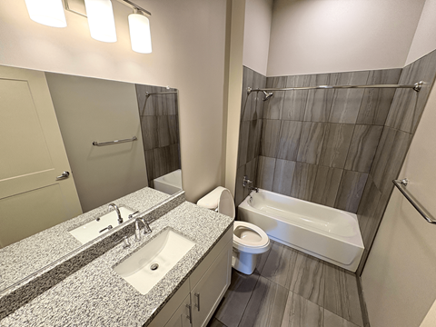 A bathroom with a sink, toilet, and bathtub.