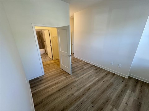 A room with a wooden floor and white walls.
