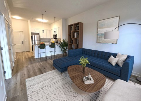 A blue couch sits in a living room with a coffee table in front of it.